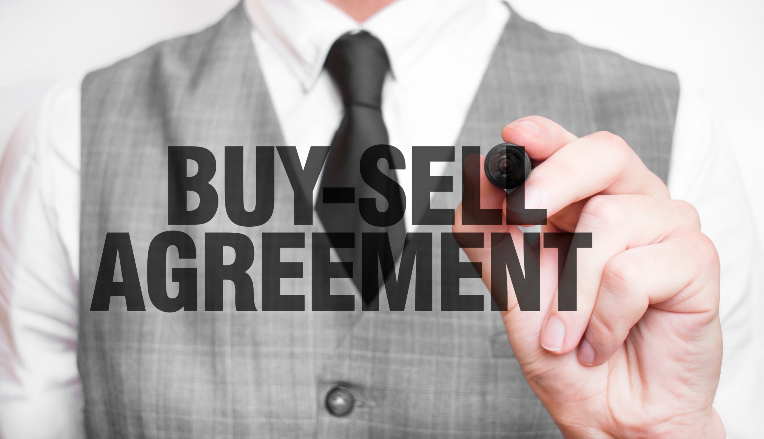 BUY SELL AGREEMENT word made by marker and hand