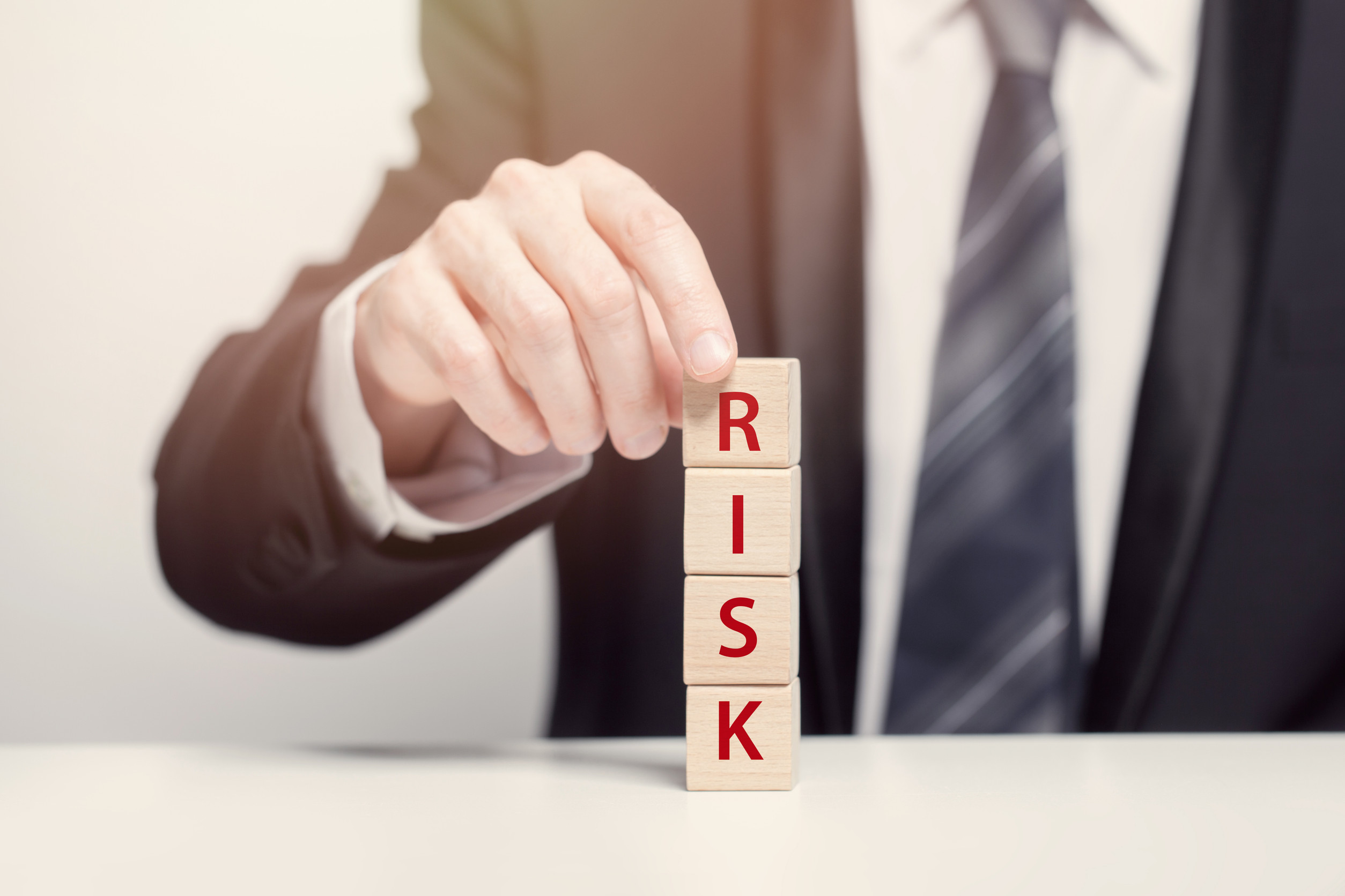Business riks concept, wooden cubes with sing risk